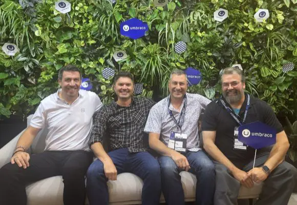 Four men sitting together at a tech conference